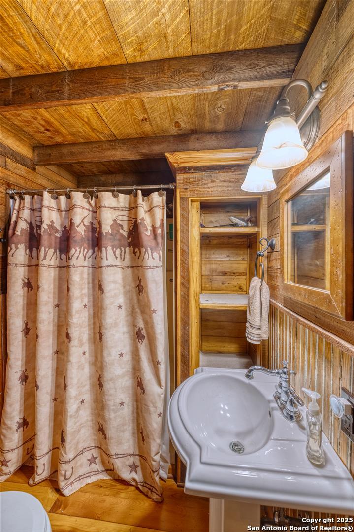 2242 Patterson Creek Road Leakey, TX 78873 - Photo 37 of 57 a bathroom with a sink a toilet and shower