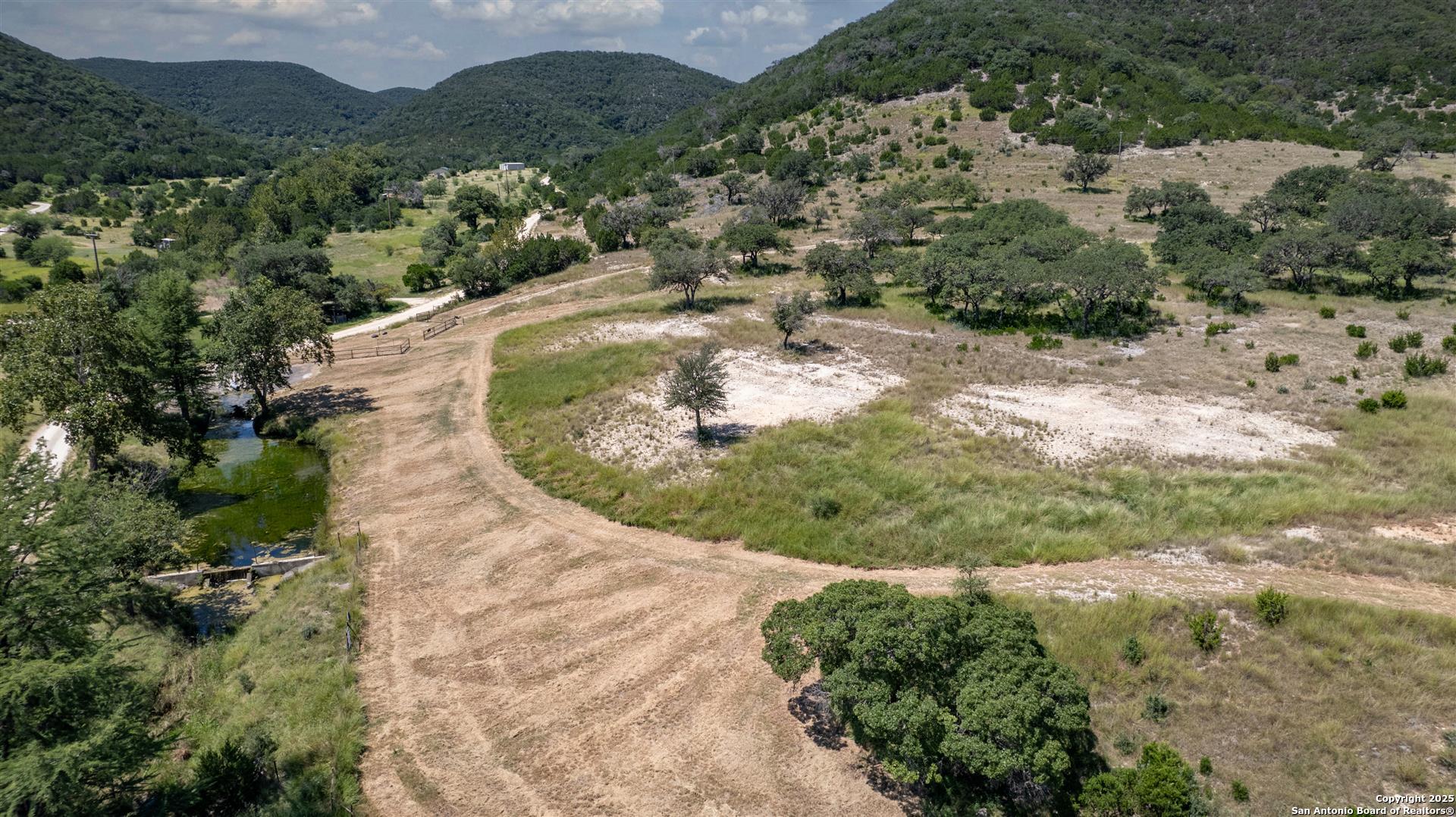 2242 Patterson Creek Road Leakey, TX 78873 - Photo 4 of 57 an aerial view of a house with a yard and mountains