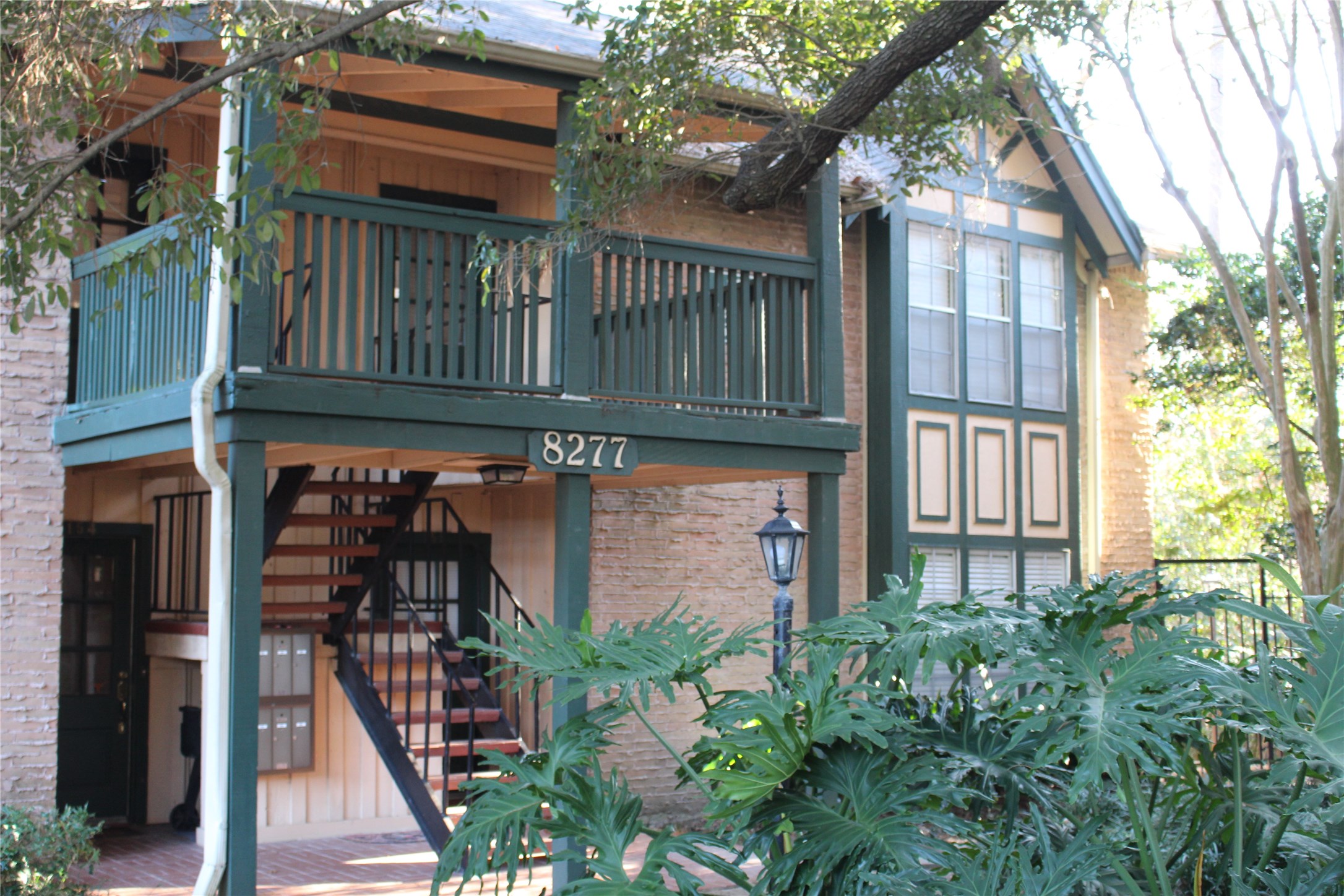 8277 Kingsbrook Road, Unit 255 Houston, TX 77024 - Photo 1 of 27 a view of a house with large windows and plants