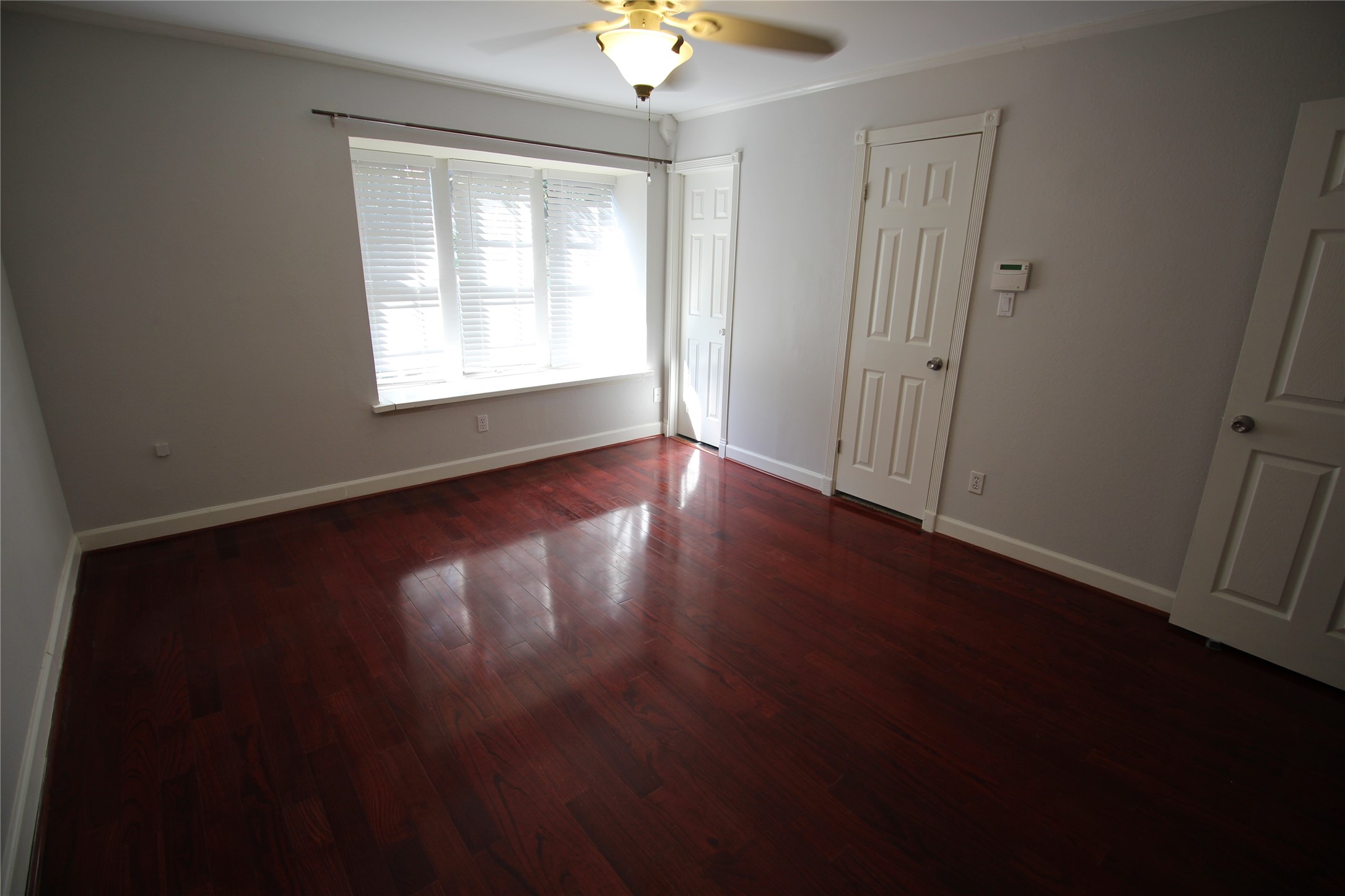 8277 Kingsbrook Road, Unit 255 Houston, TX 77024 - Photo 13 of 27 a view of an empty room with wooden floor and a window