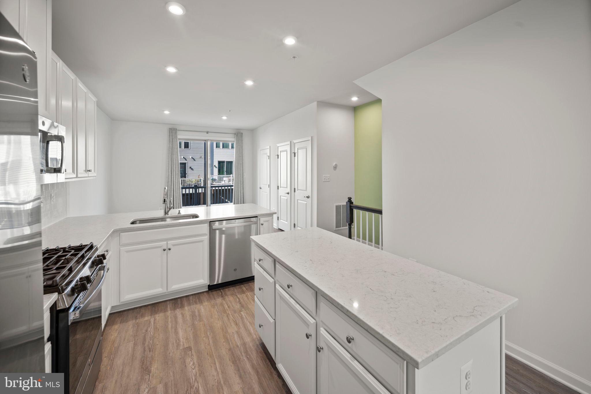 3769 Cedar Mountain Way Hanover, MD 21076 - Photo 10 of 52 a kitchen with a sink stove and cabinets