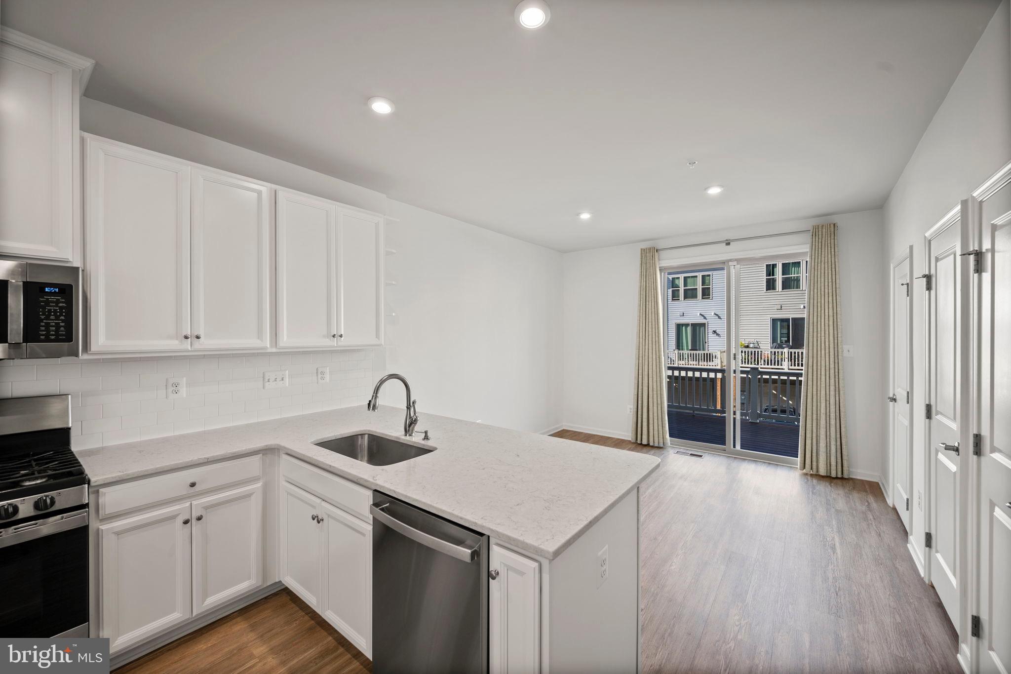 3769 Cedar Mountain Way Hanover, MD 21076 - Photo 11 of 52 a kitchen with granite countertop a sink cabinets and stainless steel appliances