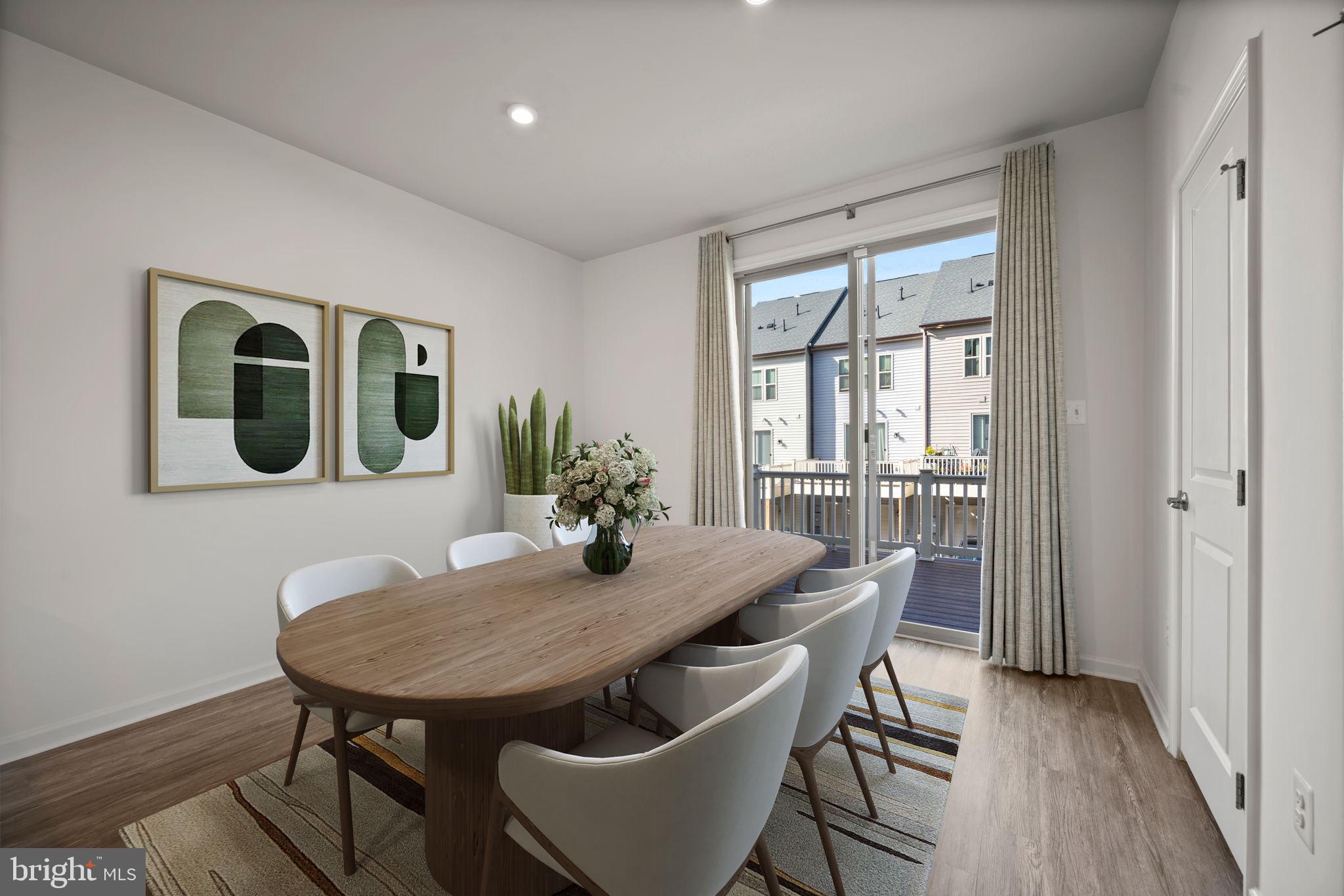 3769 Cedar Mountain Way Hanover, MD 21076 - Photo 12 of 52 a view of a dining room with furniture window and wooden floor