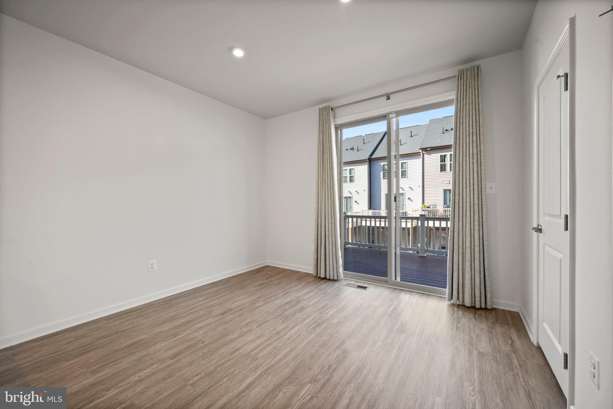 3769 Cedar Mountain Way Hanover, MD 21076 - Photo 13 of 52 wooden floor in an empty room with a window