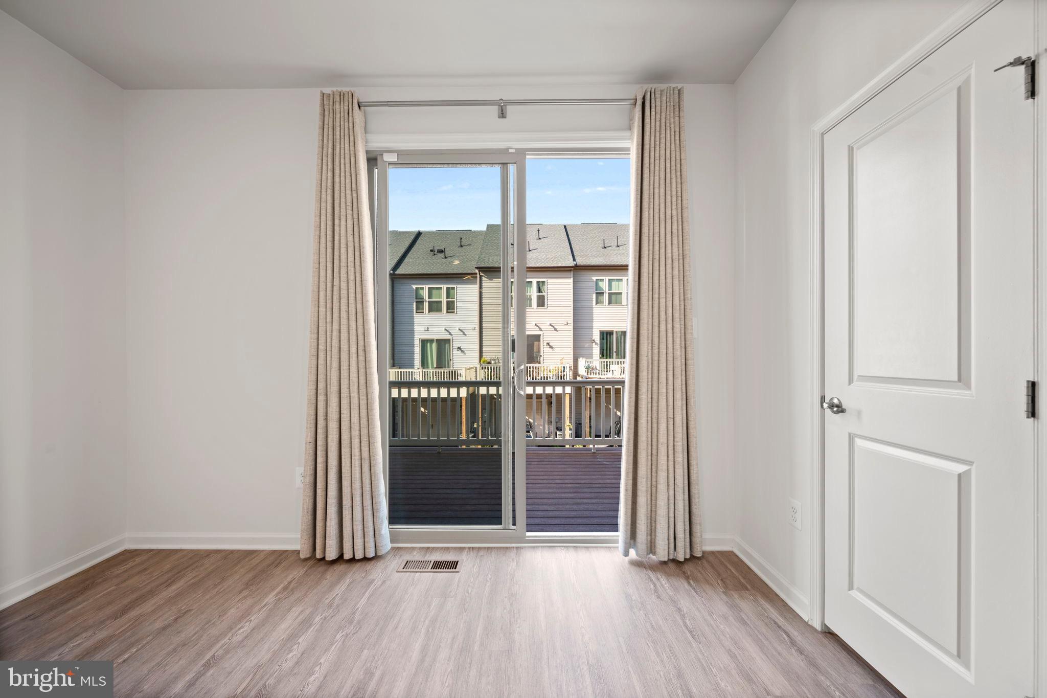 3769 Cedar Mountain Way Hanover, MD 21076 - Photo 15 of 52 an empty room with wooden floor and windows