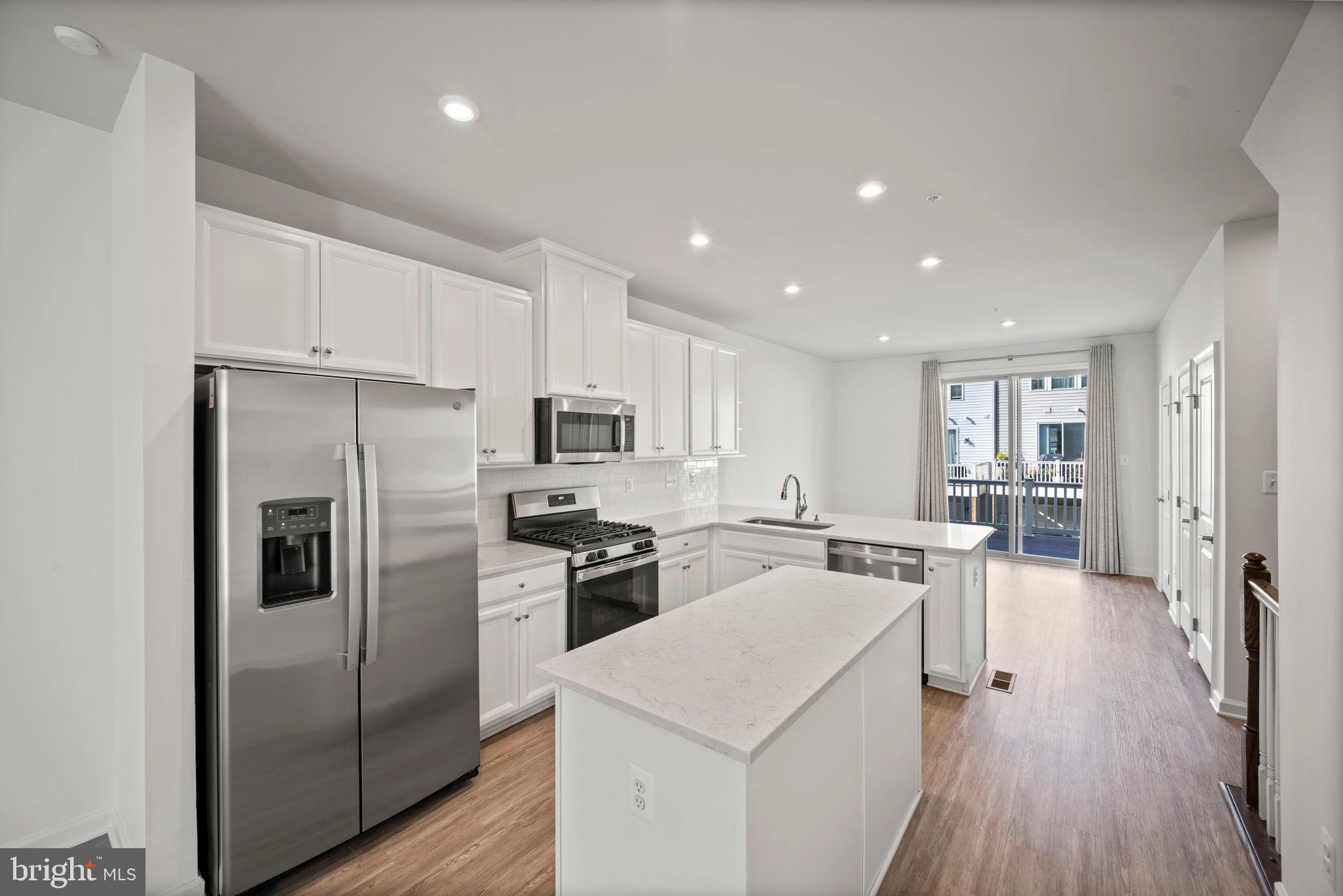 3769 Cedar Mountain Way Hanover, MD 21076 - Photo 6 of 52 a kitchen with stainless steel appliances a refrigerator stove microwave and cabinets