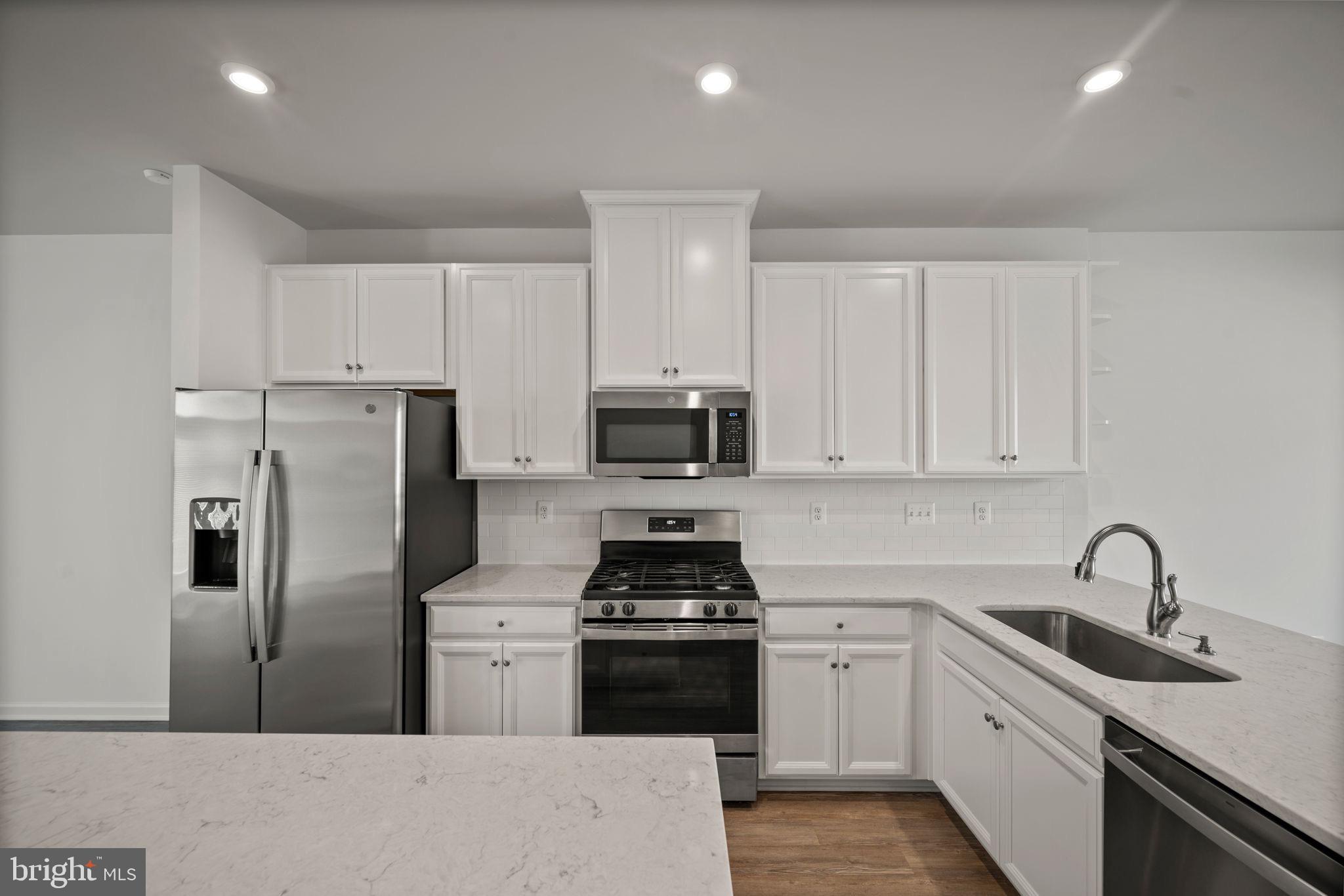 3769 Cedar Mountain Way Hanover, MD 21076 - Photo 9 of 52 a kitchen with refrigerator a sink and cabinets