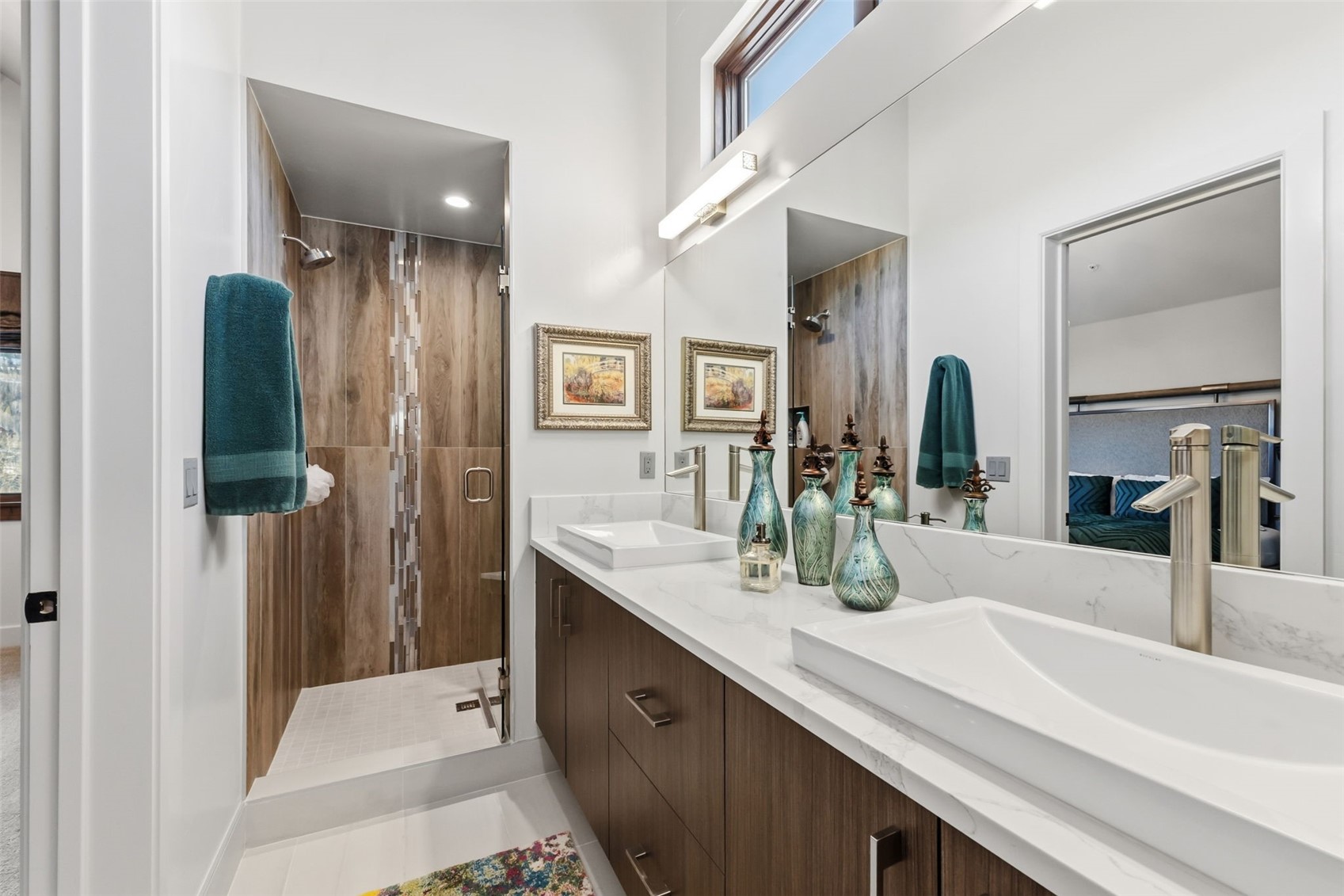 240 Game Trail Road Silverthorne, CO 80498 - Photo 31 of 49 a bathroom with a double vanity sink a mirror and shower