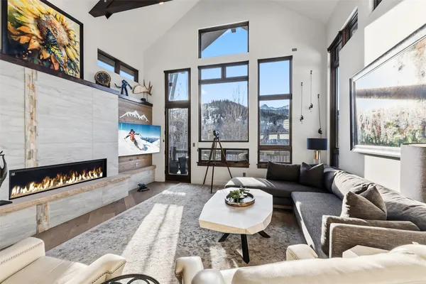 a living room with furniture and a floor to ceiling window