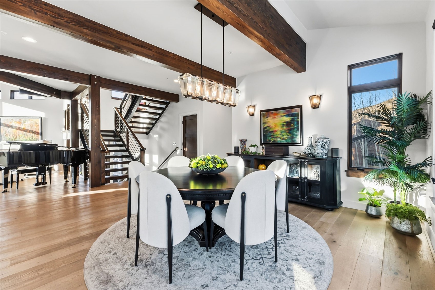 240 Game Trail Road Silverthorne, CO 80498 - Photo 10 of 49 a dining room with furniture potted plants and wooden floor