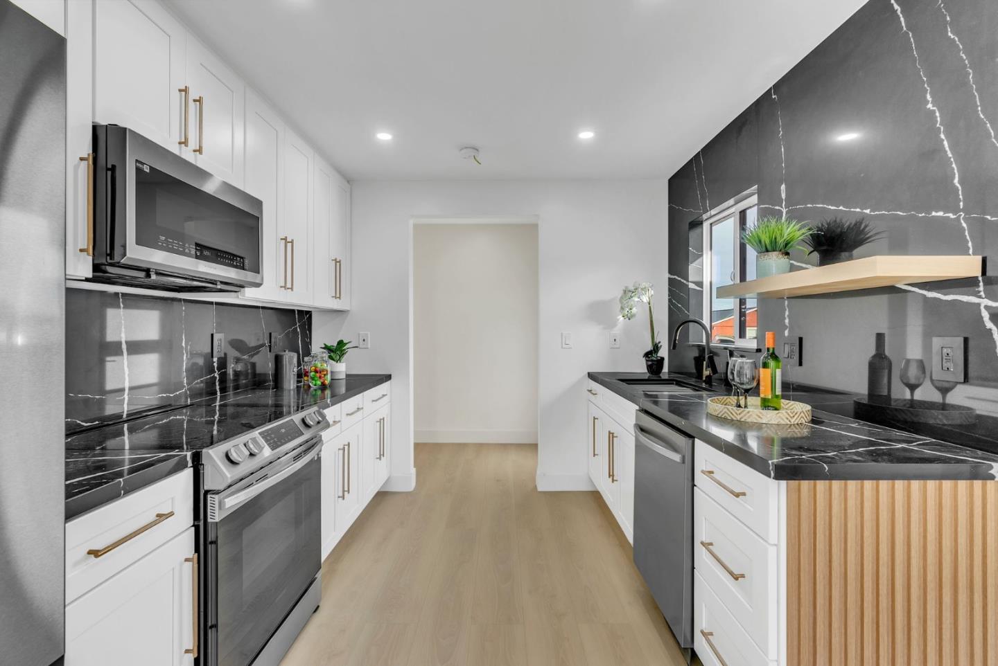 2011 Willow Way San Bruno, CA 94066 - Photo 14 of 57 a kitchen with stainless steel appliances granite countertop a stove top oven microwave and cabinets