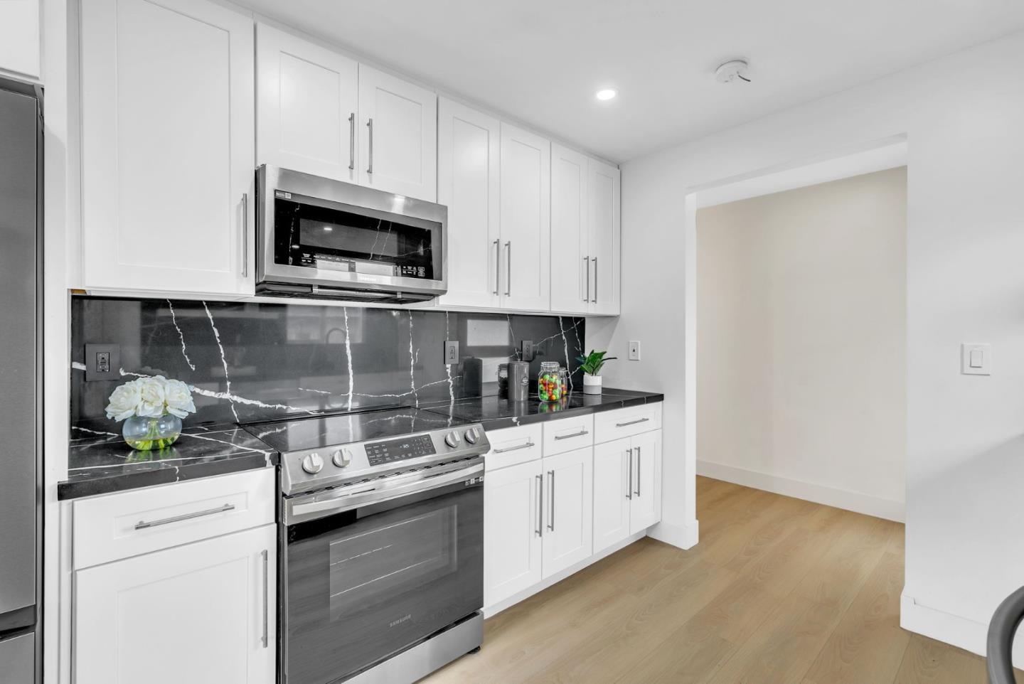 2011 Willow Way San Bruno, CA 94066 - Photo 17 of 57 a kitchen with stainless steel appliances granite countertop white cabinets and a stove