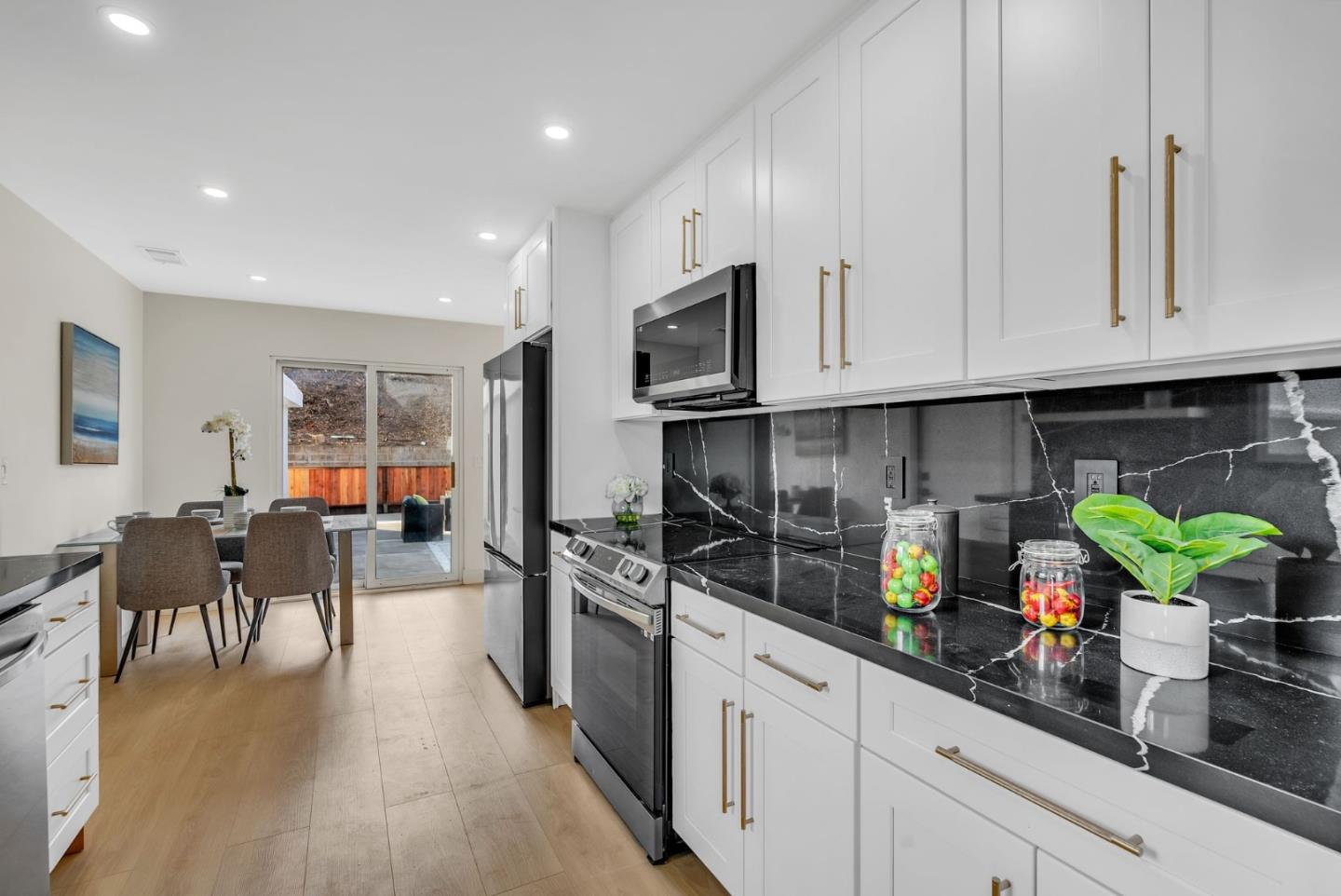 2011 Willow Way San Bruno, CA 94066 - Photo 20 of 57 a kitchen with white cabinets and wooden floor