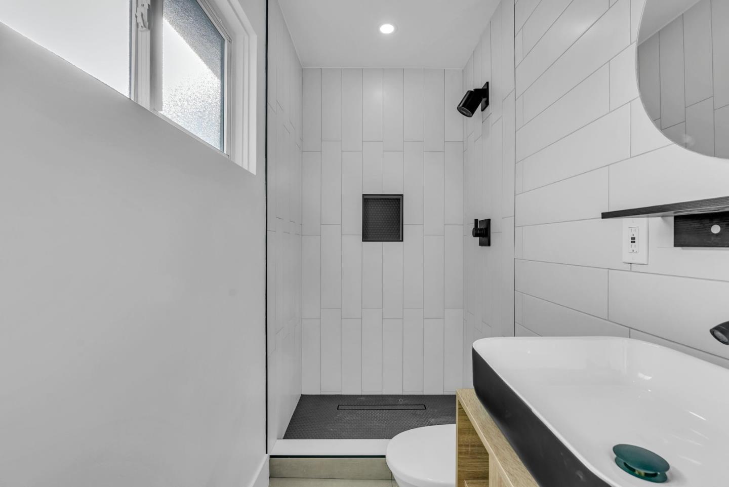 2011 Willow Way San Bruno, CA 94066 - Photo 28 of 57 a bathroom with a sink a toilet a mirror and shower