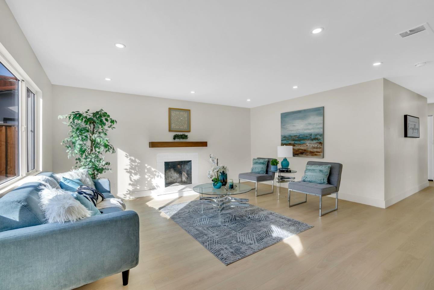 2011 Willow Way San Bruno, CA 94066 - Photo 9 of 57 a living room with furniture a fireplace and a potted plant