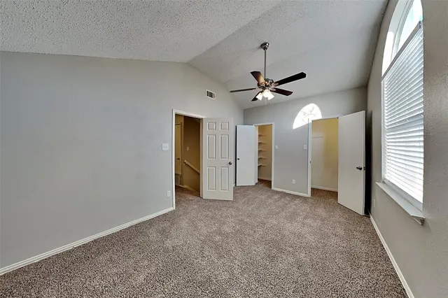 a view of a livingroom with a ceiling fan and window