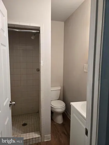 a bathroom with a toilet and a shower