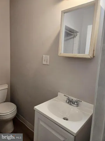 a bathroom with a sink mirror and toilet