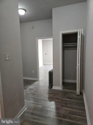 a view of hallway with wooden floor