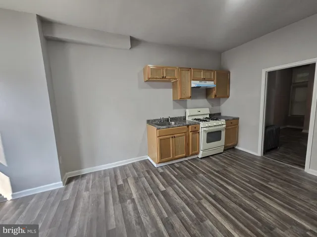 a kitchen with a stove top oven and cabinets