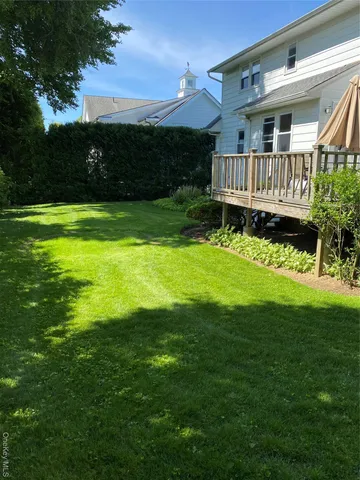 a view of a house with a yard and deck