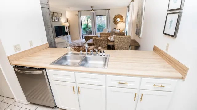 a view of kitchen sink and cabinet