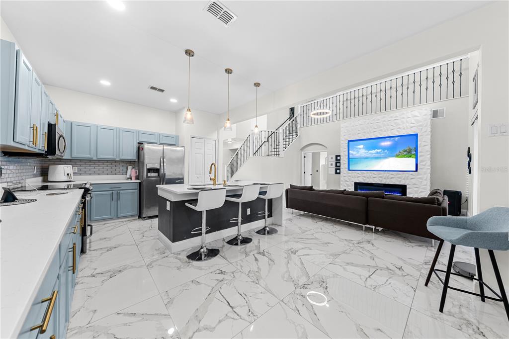 4301 Presidio Way Kissimmee, FL 34746 - Photo 14 of 50 a living room with stainless steel appliances kitchen island granite countertop furniture and a view of kitchen