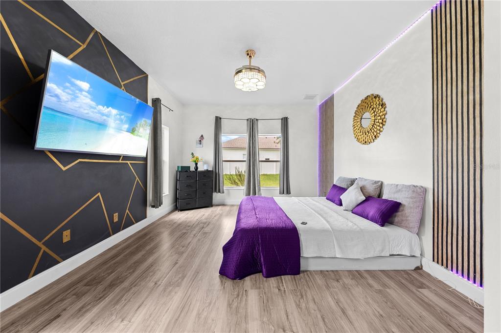 4301 Presidio Way Kissimmee, FL 34746 - Photo 20 of 50 a bedroom with a bed and a flat screen tv