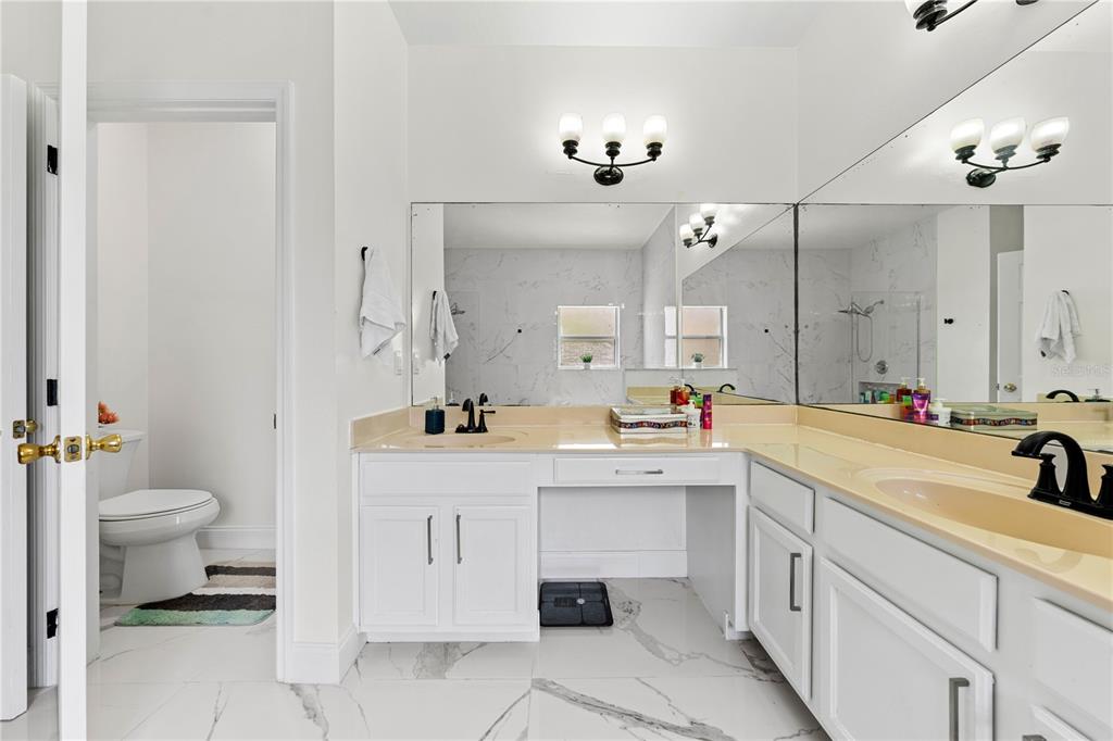 4301 Presidio Way Kissimmee, FL 34746 - Photo 23 of 50 a bathroom with a sink a toilet and mirror