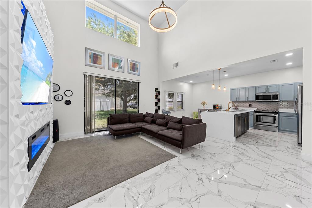 4301 Presidio Way Kissimmee, FL 34746 - Photo 7 of 50 a living room with furniture and a fireplace
