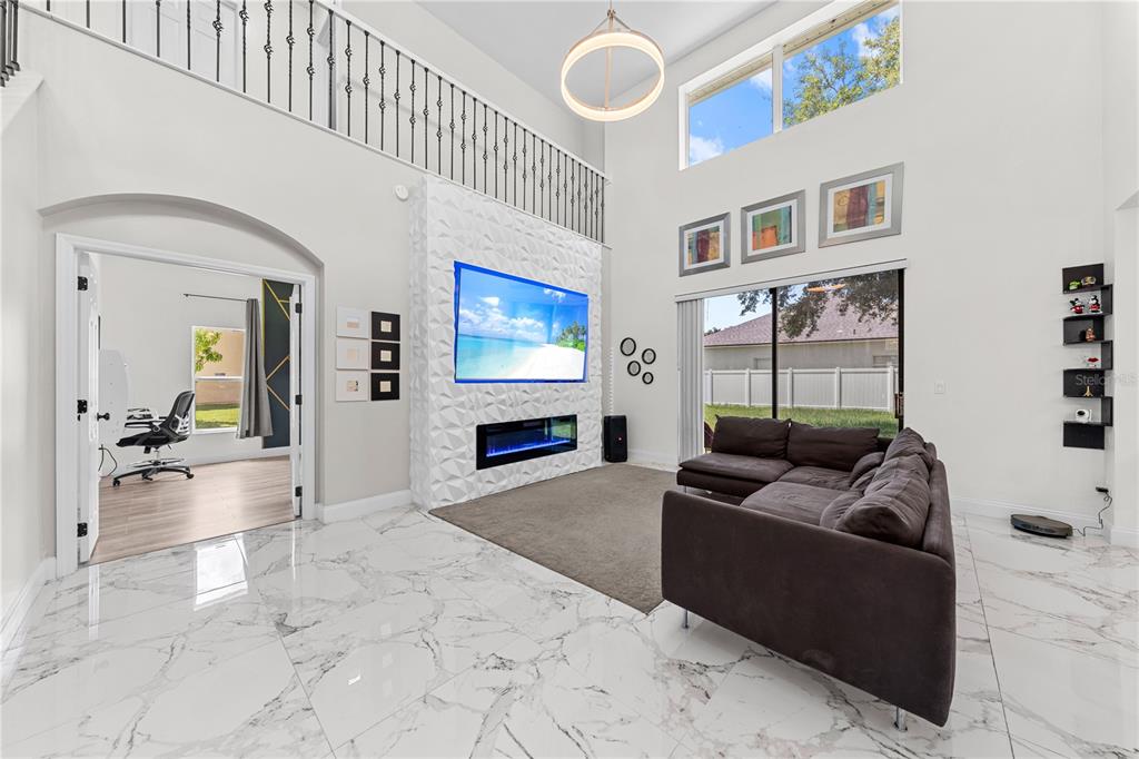 4301 Presidio Way Kissimmee, FL 34746 - Photo 8 of 50 a living room with furniture and a fireplace