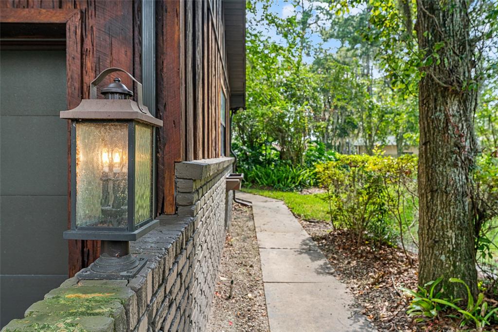 8101 Northwest 46th Street Ocala, FL 34482 - Photo 2 of 71 a view of a pathway of a house with potted plants