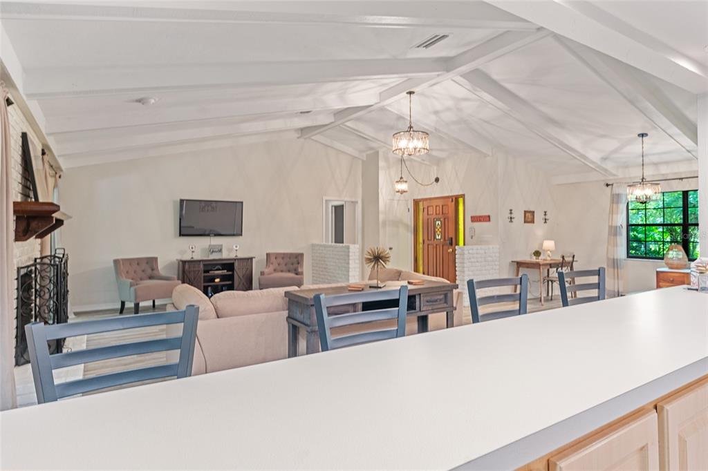 8101 Northwest 46th Street Ocala, FL 34482 - Photo 34 of 71 a living room with furniture a flat screen tv and a large window