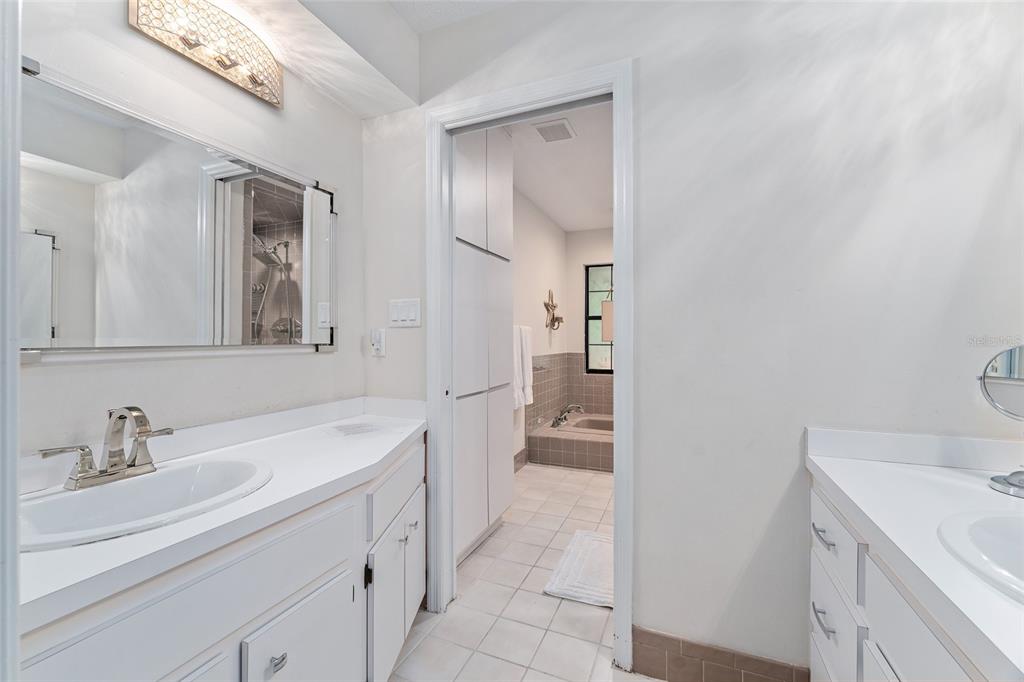 8101 Northwest 46th Street Ocala, FL 34482 - Photo 44 of 71 a spacious bathroom with a sink a toilet and a mirror