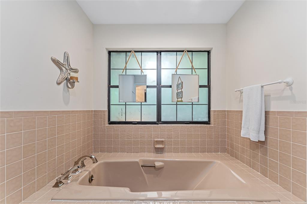 8101 Northwest 46th Street Ocala, FL 34482 - Photo 46 of 71 a bathroom with a bath tub and a shower