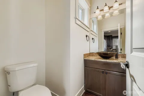 a bathroom with a toilet a sink and a mirror