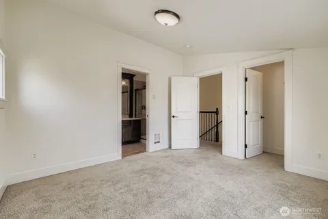 an empty room with closet and a bathroom