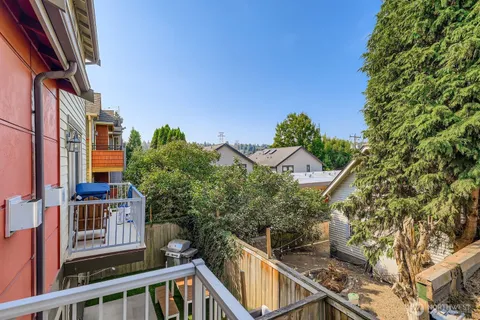 a view of a house with a wooden fence