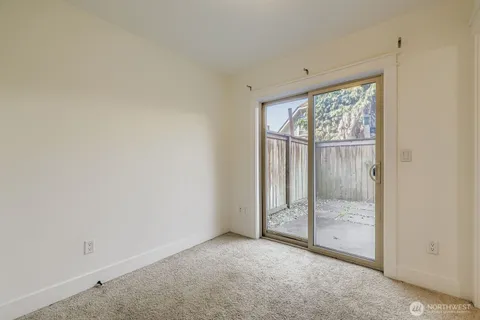 a view of an empty room with glass door