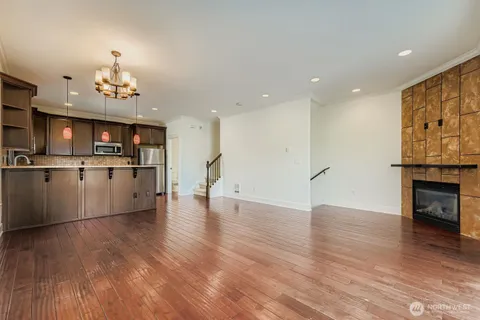a view of a kitchen with furniture and wooden floor