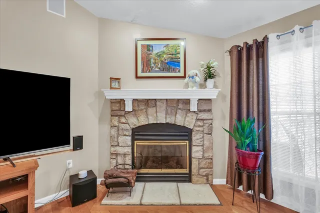 a living room with furniture kitchen view and a chandelier