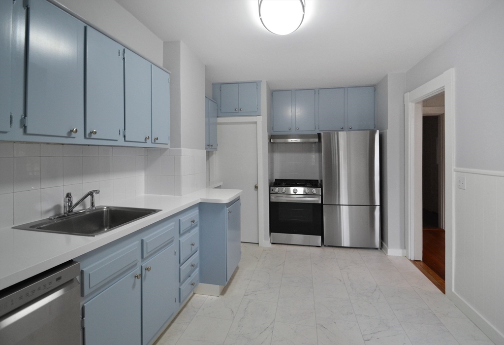 a kitchen with a sink and refrigerator