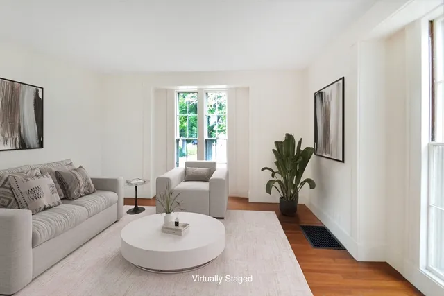 a living room with furniture and a potted plant