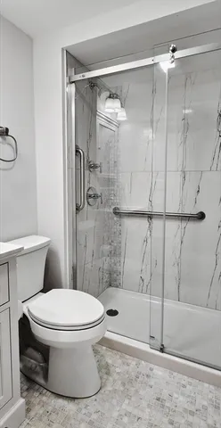 a bathroom with a toilet and a shower