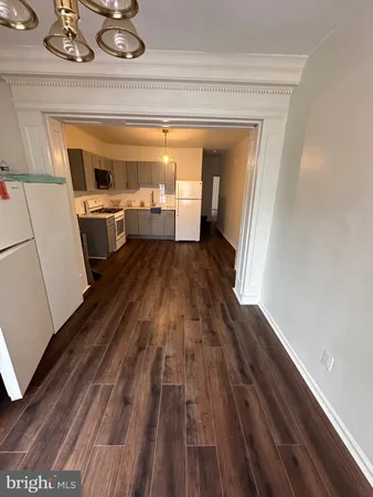 a view of a room with wooden floor