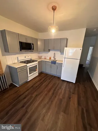a kitchen with a sink a microwave a stove and refrigerator