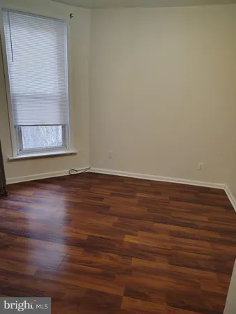 a view of room with window and wooden floor
