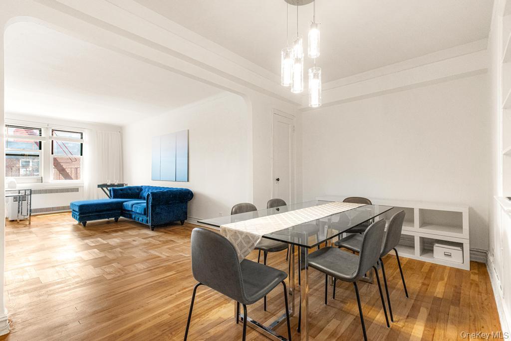 100-10 67th Road, Unit 6L Queens, NY 11375 - Photo 11 of 26 a view of a dining room with furniture and a chandelier