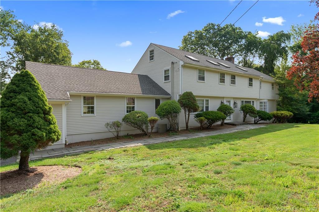 a view of a house with a yard and plants
