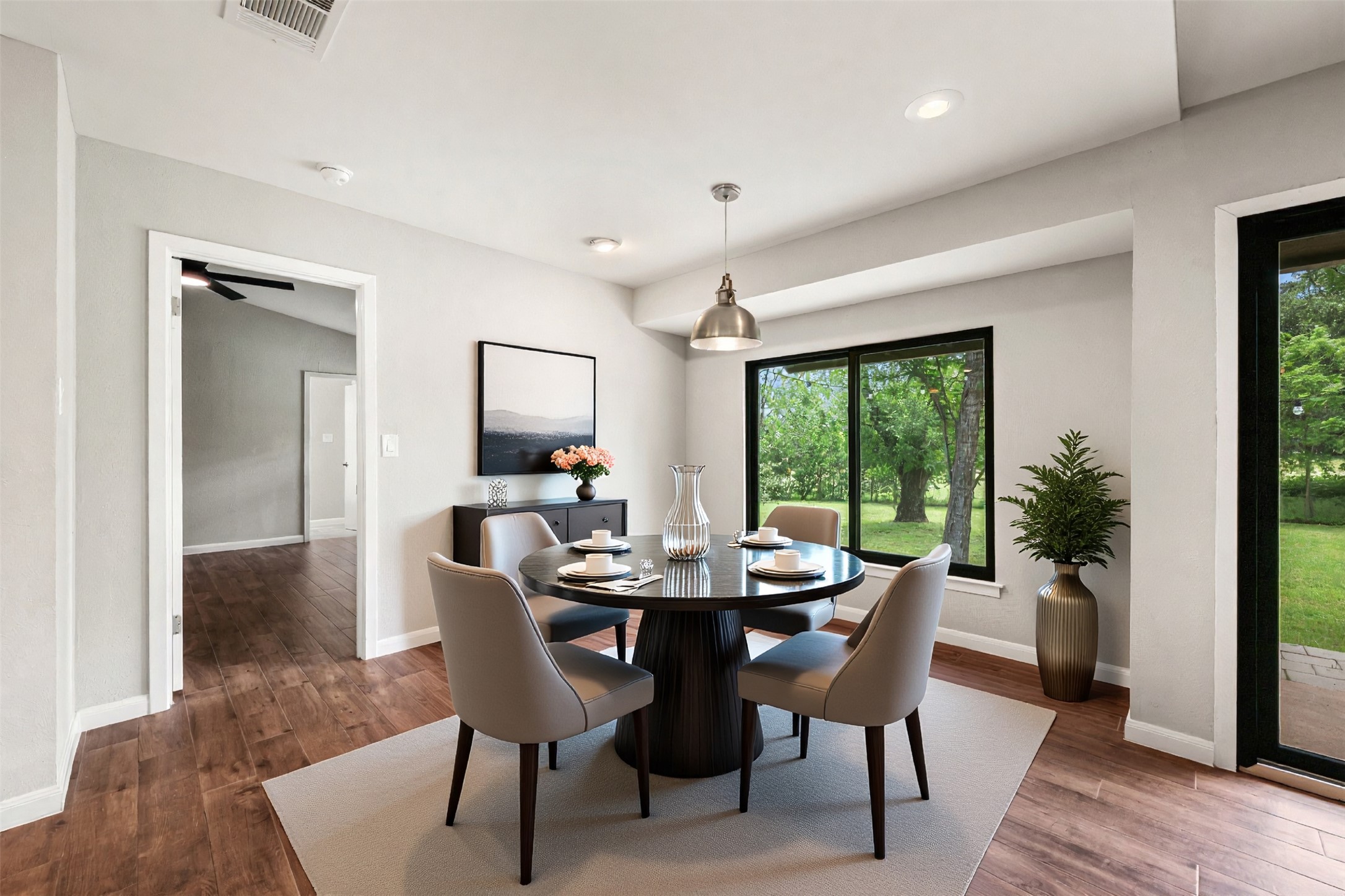 1600 Pin Oak Lane Round Rock, TX 78681 - Photo 15 of 40 Dining area featuring wood-finish flooring, a contemporary pendant light fixture, recessed ceiling lights, and abundant natural light from a large window
